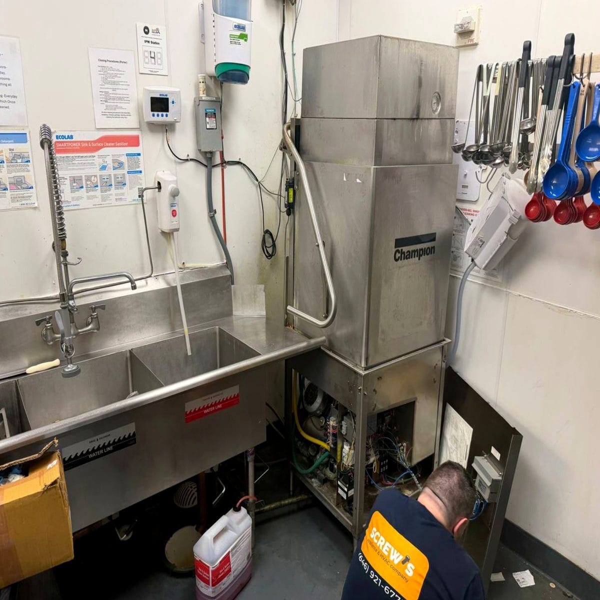 SCREWS Appliance Repair technician diagnosing a commercial dishwasher drain issue in NYC
